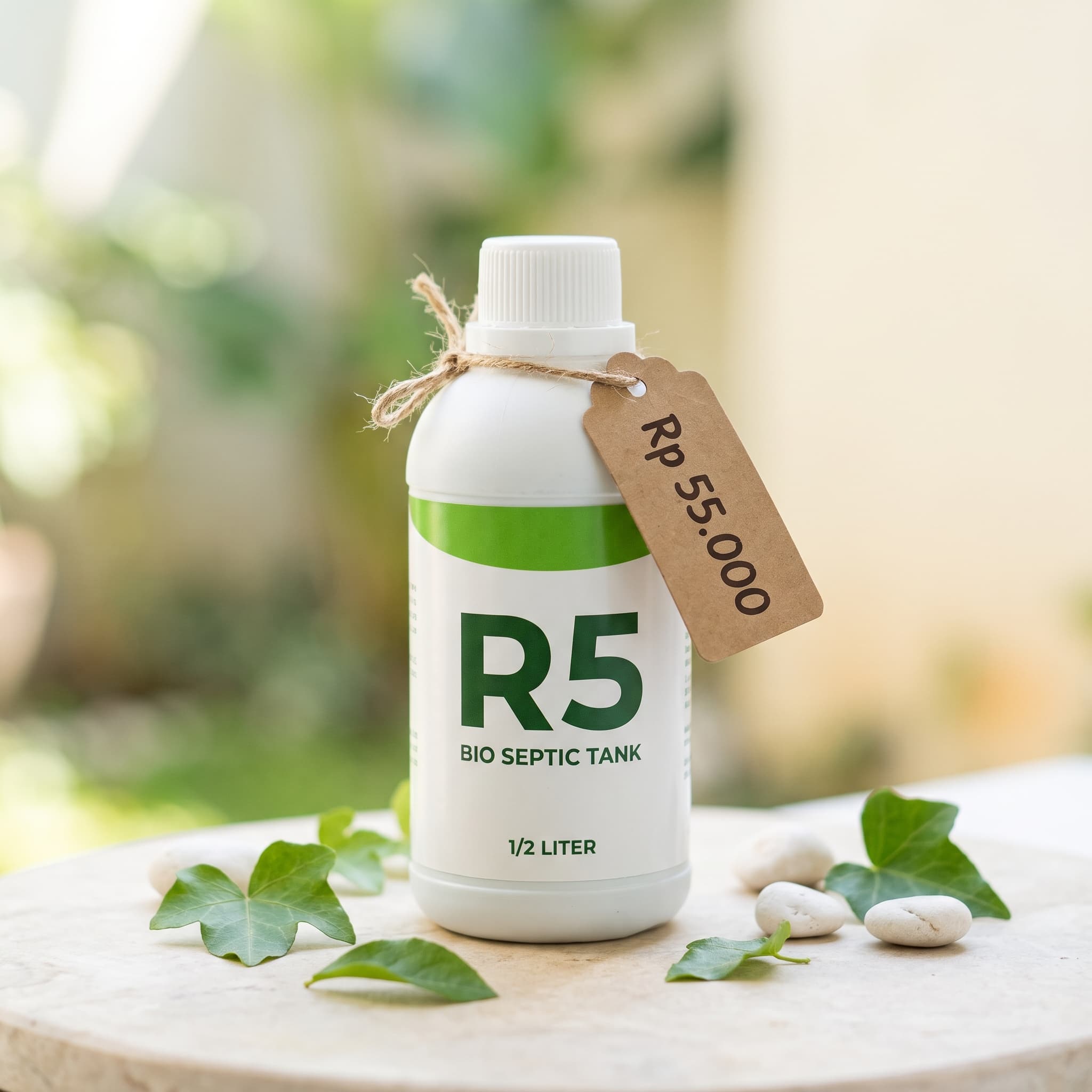 Botol Bio Septic Tank kemasan 1/2 liter berlabel putih hijau dengan label harga Rp 55.000 di atas batu alam